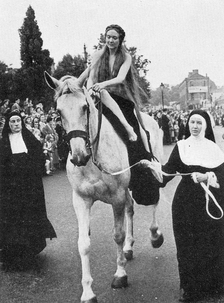 Image showing Ann Wragg "dressed" as Lady Godiva on a horse accompanied by two nuns.