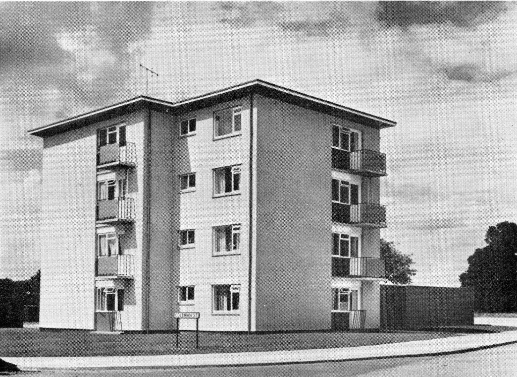 Monochrome photograph of a four storey block of flats in Tile Hill Coventry