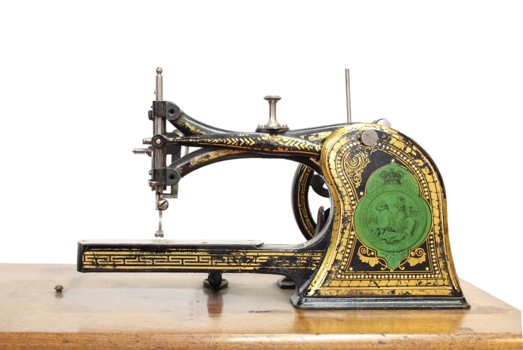 Photograph of a rather fine sewing machine with gold decoration.