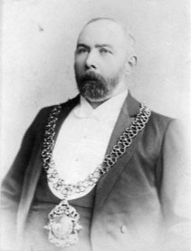 Old monochrome photograph of George Singer as Mayor with chain and badge of office.