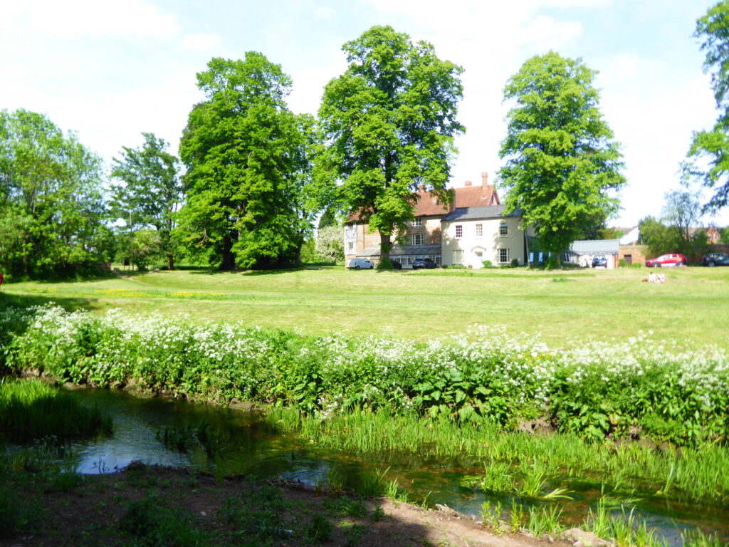 Photograph showing the river in the foreground and Charterhouse behind.