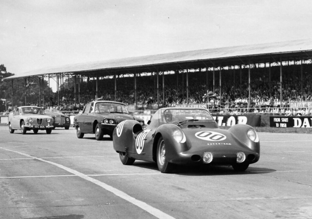 Monochrome photo of four gar turbine driven Rover Cars at a race track.