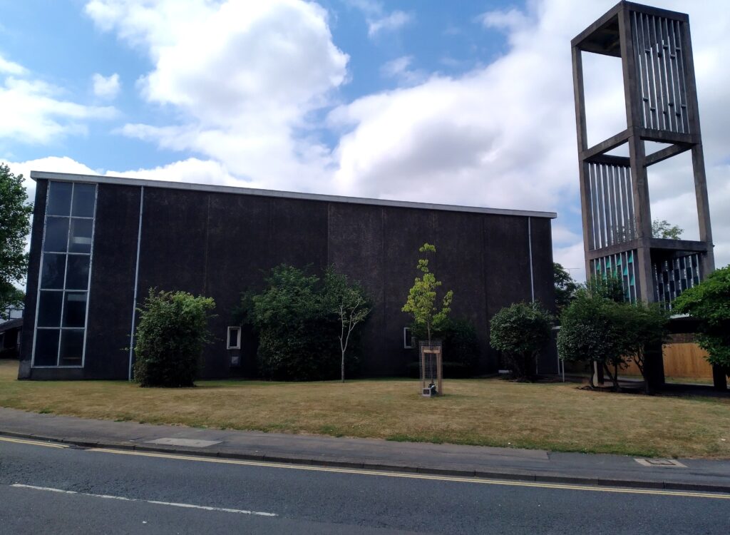 Colour photograph of a modern church in Willenhall, Coventry, showing an open tower.