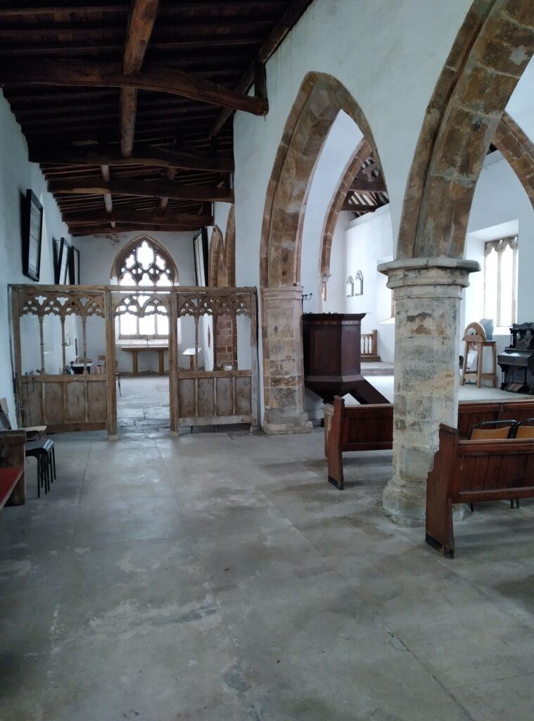 View of the inside of St. Peter's Church showing pilars and pews.