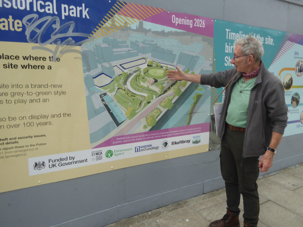 P:hotograph of Simon Ogden pointing out the plans for Sheffield castle.